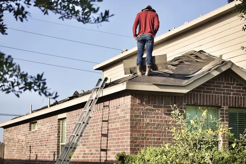 Professional roofer working on a residential roof in Elkhorn Woods
